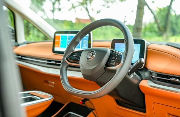 Steering wheel features controls for the music volume, cruise control speed, and telephony. Two-spoke wheel looks modern while the boss houses the horn-pad.